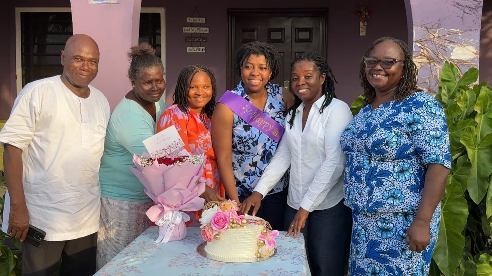 Ebenezer with family around a celebration cake