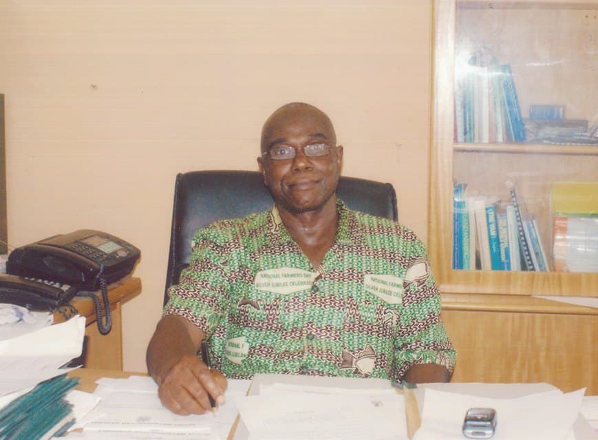 Ebenezer at his office desk