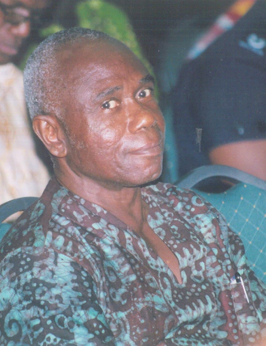 Ebenezer in a patterned shirt, looking towards the camera