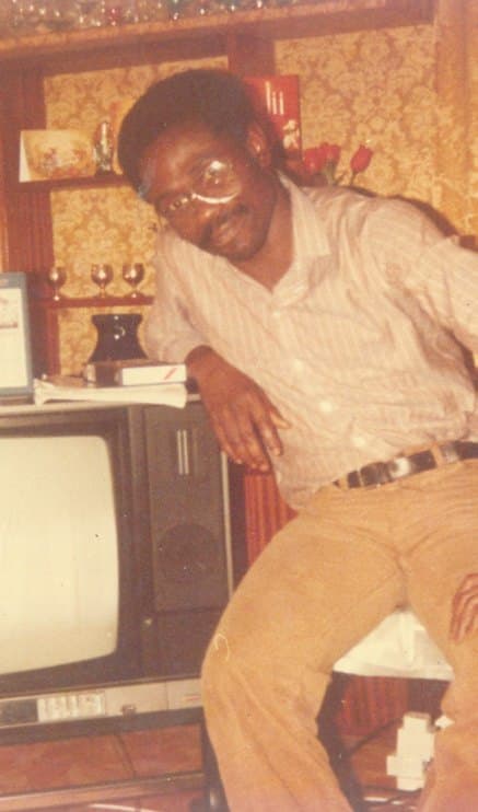 A young Ebenezer sitting beside a television set